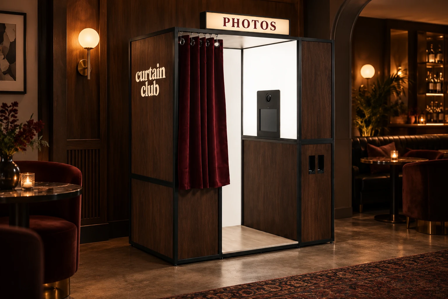 Gallery booth with a walnut-look wrap and oxblood curtain, shown as a concept inside a warmly lit bar